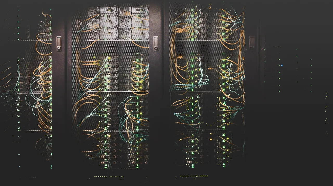 Server cabinets with cabling and status lights in a dark data centre